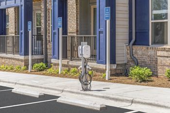 A parking meter on a sidewalk in front of a building